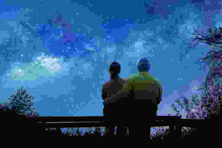 couple stargazing on bench anniversary date idea