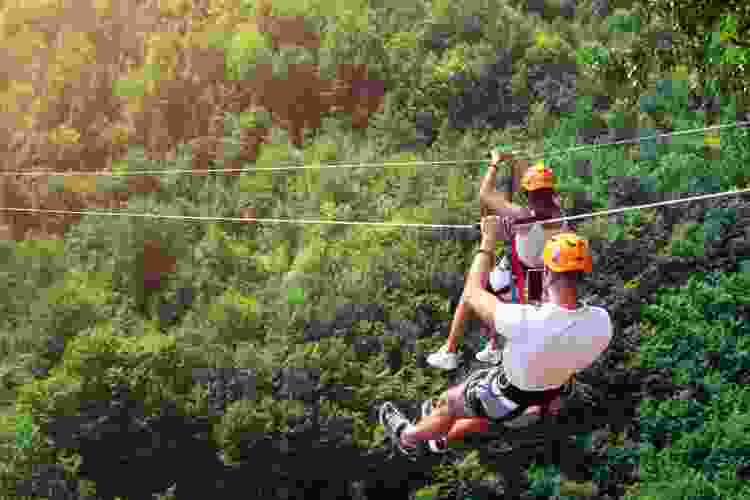 two people riding zipline anniversary date idea