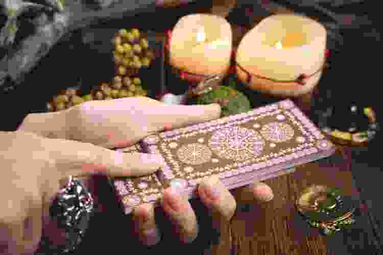 hands holding tarot cards