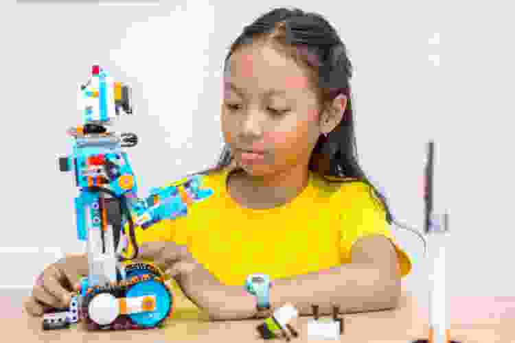 child building robot with LEGO