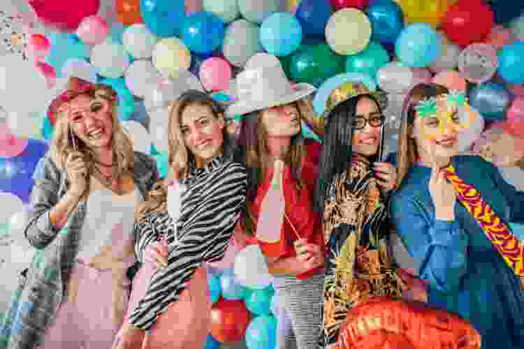 group posing with balloons and props for photo shoot