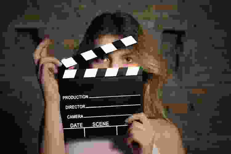 woman with clapboard over face