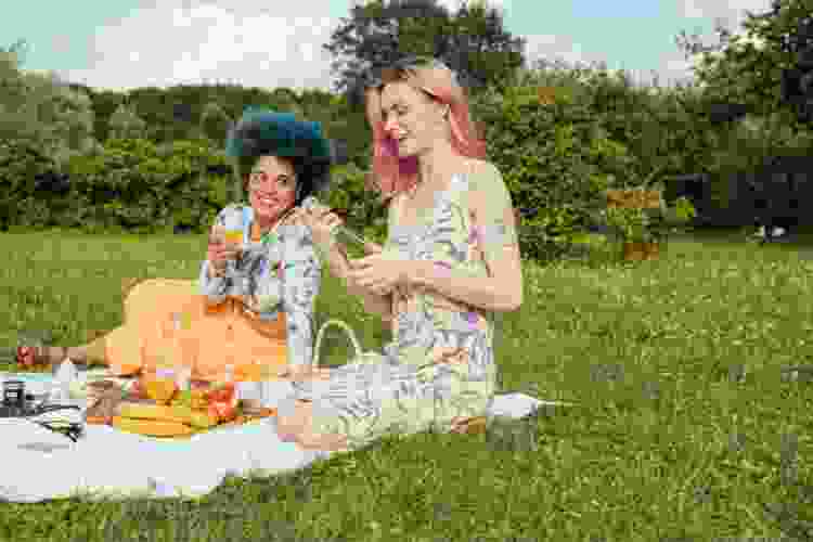 happy couple enjoying picnic in the park