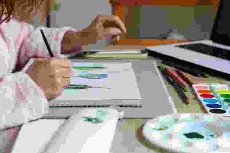 person learning to paint by computer at home