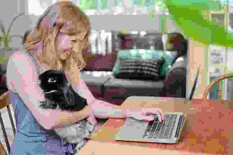 holding pet rabbit while on video call