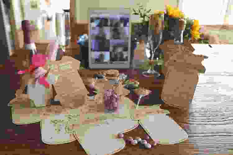 tablet video call in background of baby shower party supplies