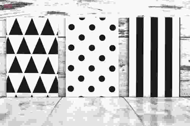 three canvases with triangles, one with circles, one with stripes