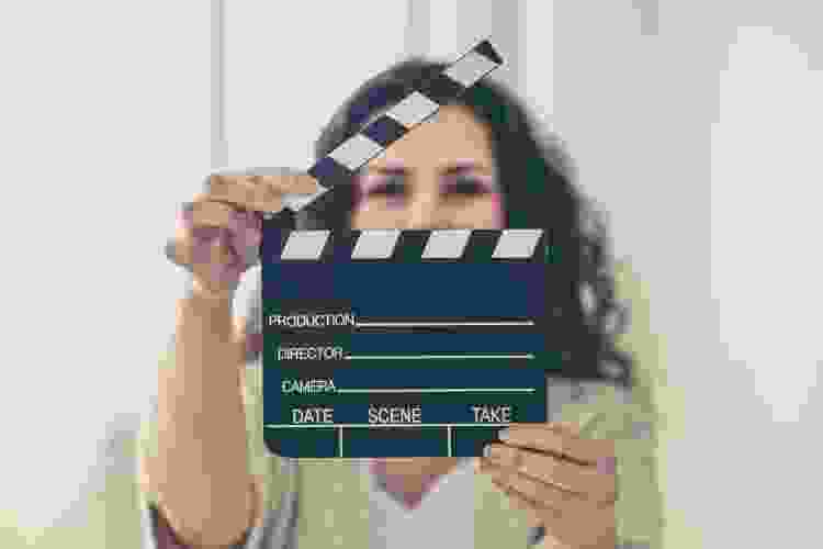 woman holding film cue marker 