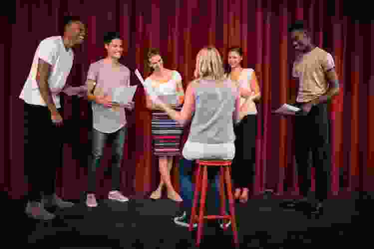 group of actors rehearsing on stage