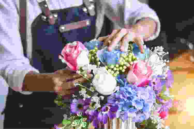 arranging pink and blue flowers