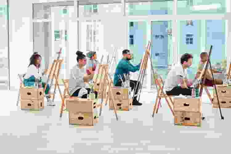 group of people taking a painting class