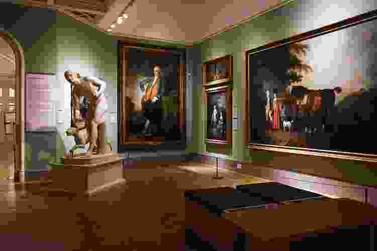 hanging art and large statues in a museum