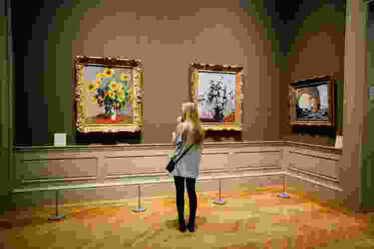 woman viewing artwork in gallery