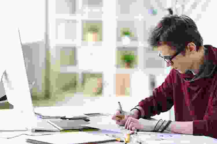 young artist studying art at his desk