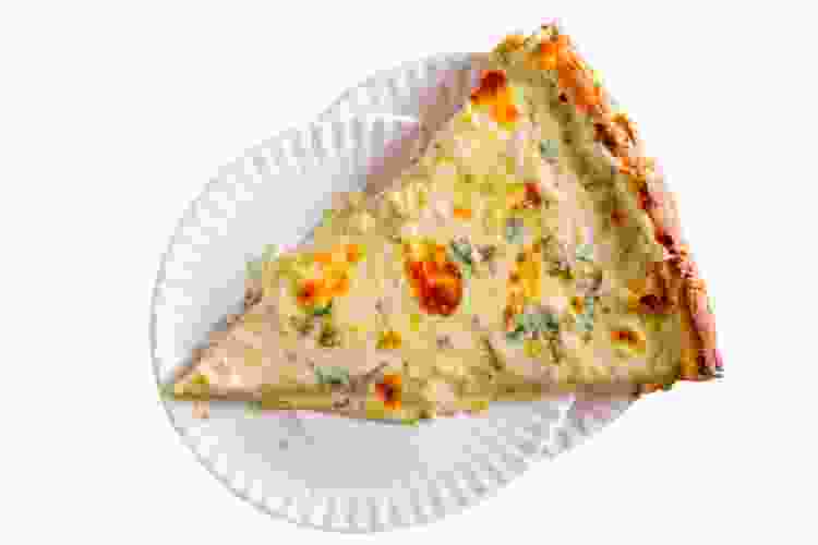 slice of artichoke pizza on paper plates for best pizza in Manhattan