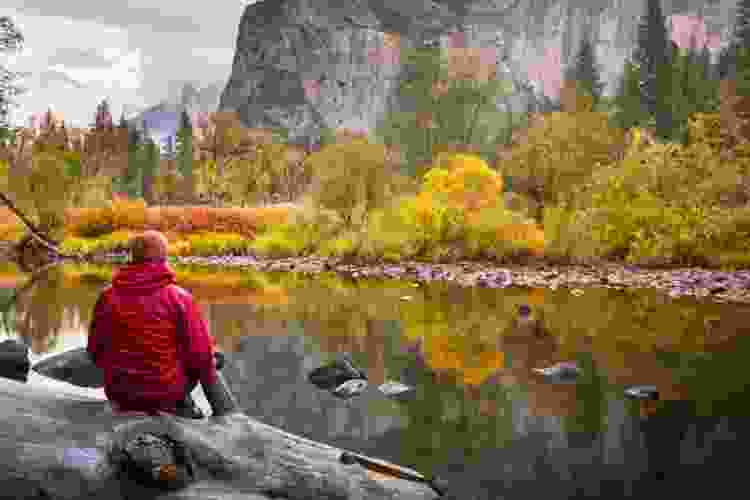 man overlooking autumn lake