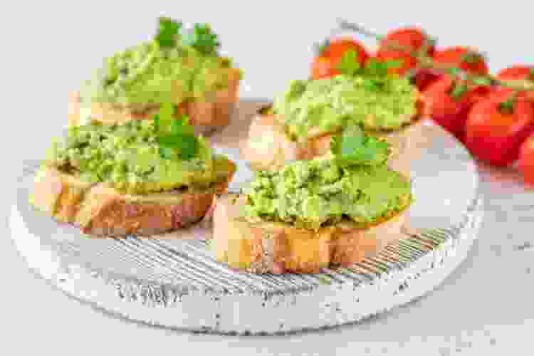 mini baguette slices topped with smashed avocado and tomatoes