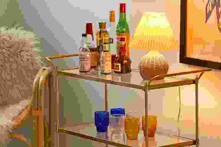 Urban Outfitters bar cart with cups and drinks