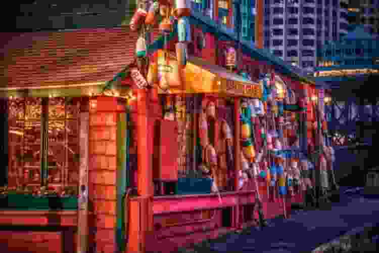 nighttime scene of Barking Crab Boston restaurant red shack with buoys hanging