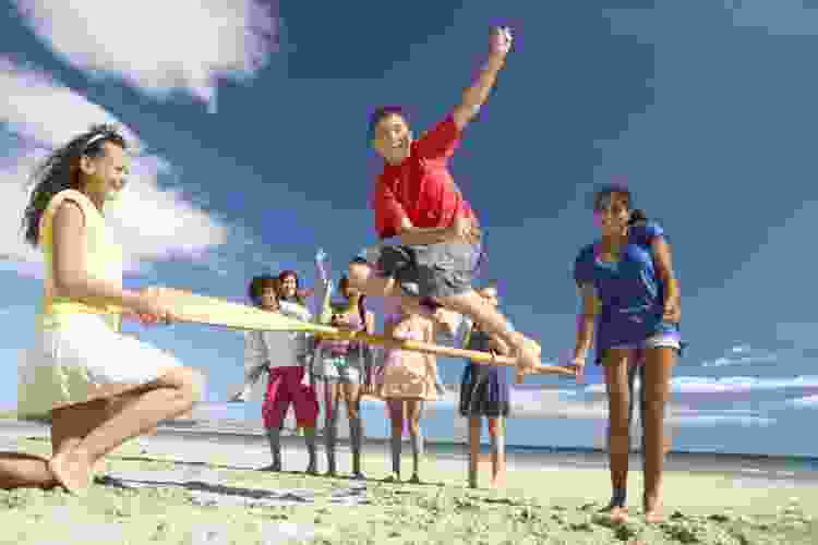 teens playing games on the beach