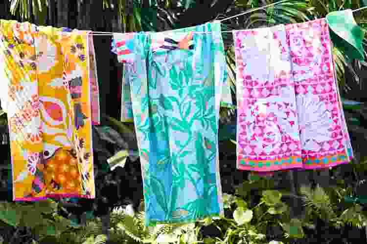 beach towels hanging on laundry wire outdoors