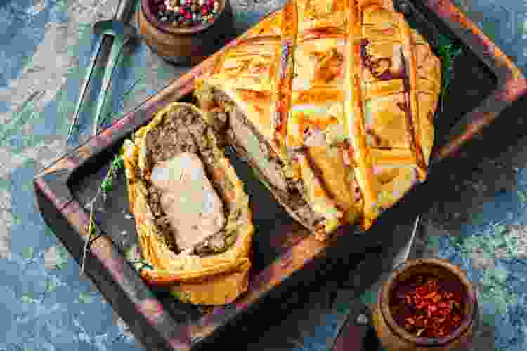 beef Wellington sliced on cutting board