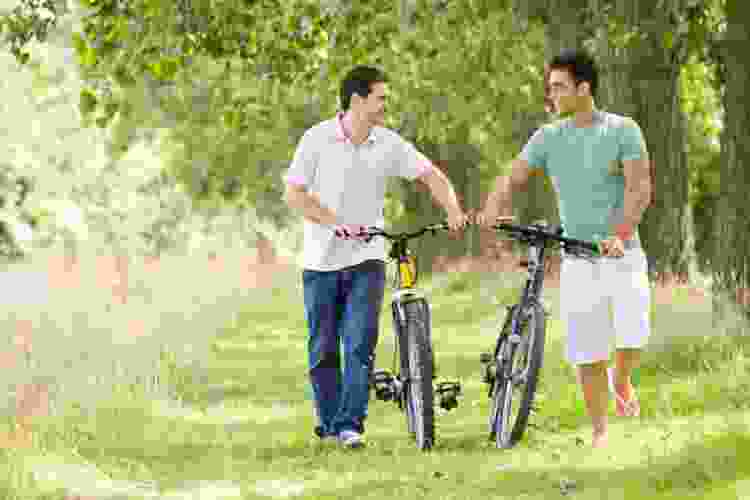 couple walking through trail with bikes