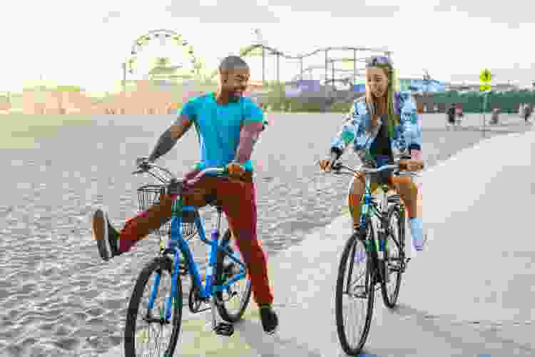 couple riding bikes on the beach