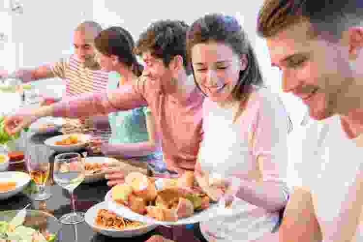 group of people having potluck dinner