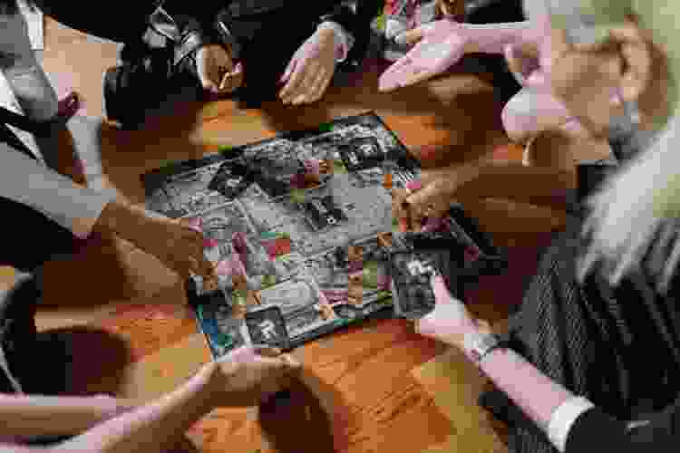 group of adults playing board games on the floor