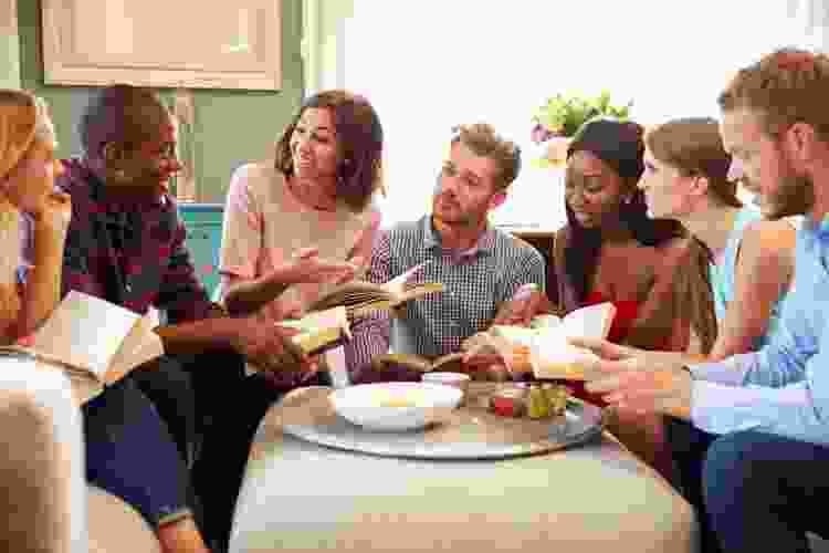 group of people discussing books in book club meeting