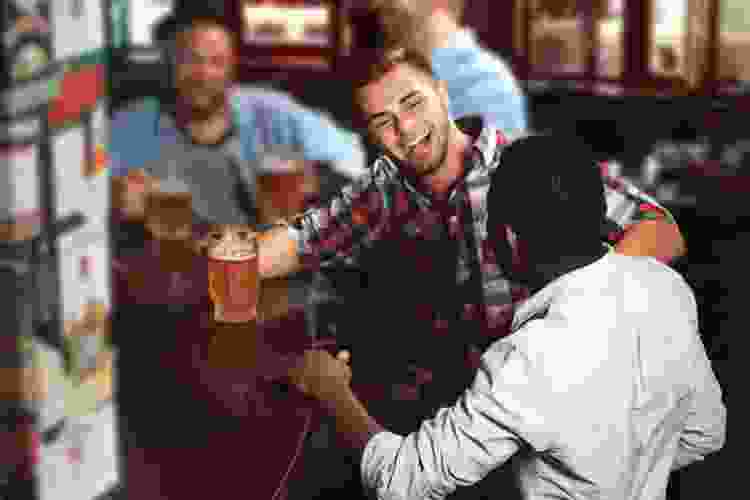 men drinking beer at a bar