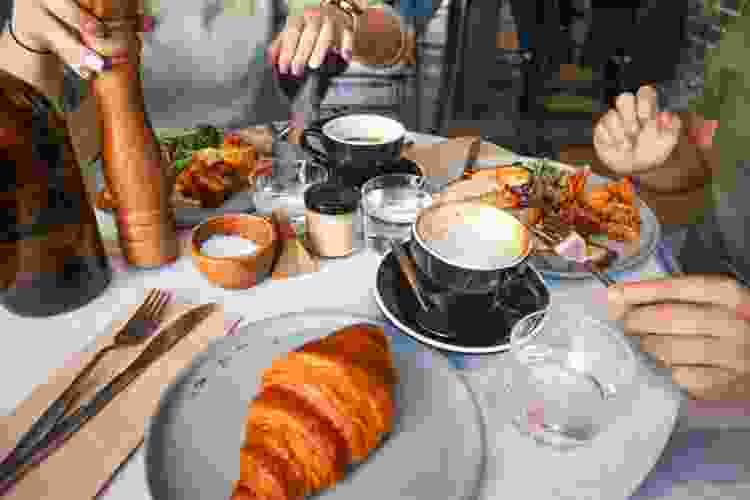 hands on table of brunch spread