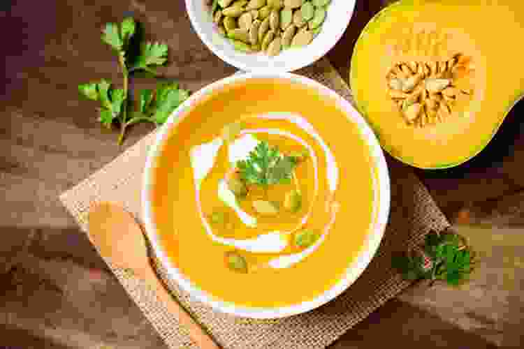 bright yellow bowl of butternut squash soup