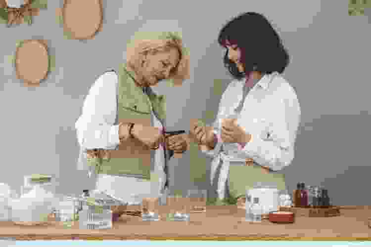 mother and daughter making candles with kit