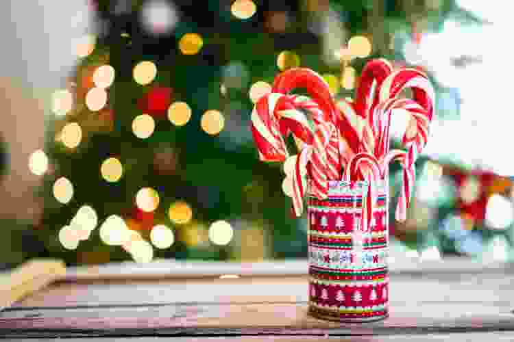 Use candy canes to decorate an ugly Christmas sweater.