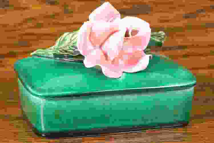 green ceramic box with pink rose on top