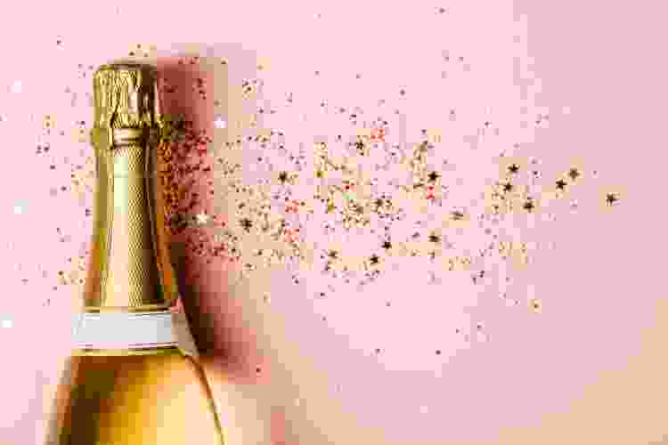 pink bottle of Champagne on silver glitter