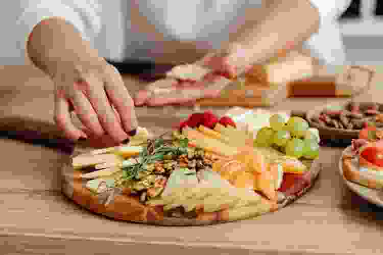 arranging cheese on charcuterie board