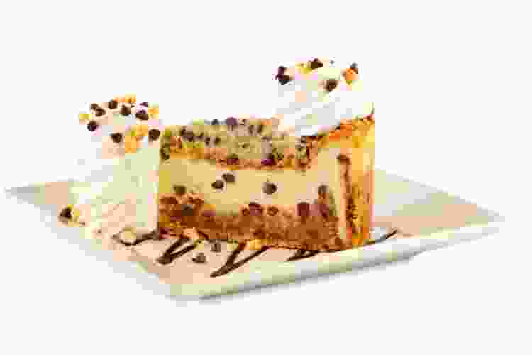 giant slice of cookie dough cheesecake on plate