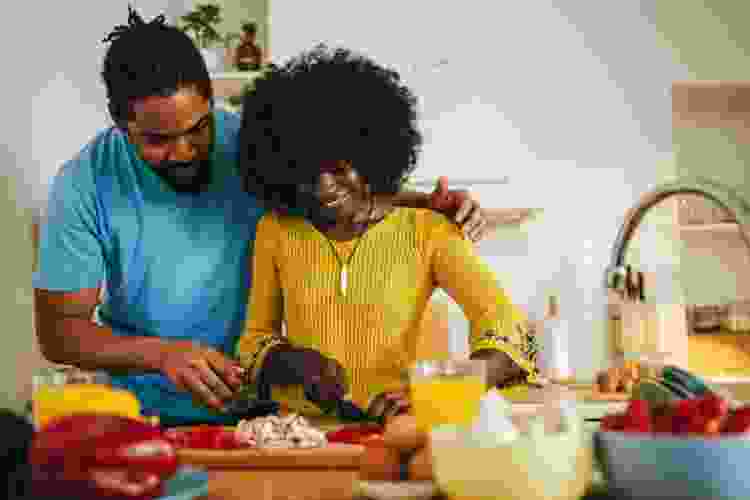 Couple chopping vegetables