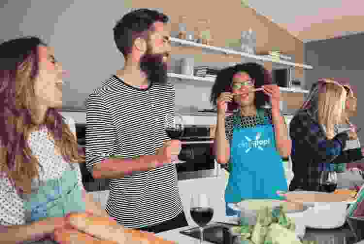 group of friends having fun in the kitchen for a cooking class Christmas activity