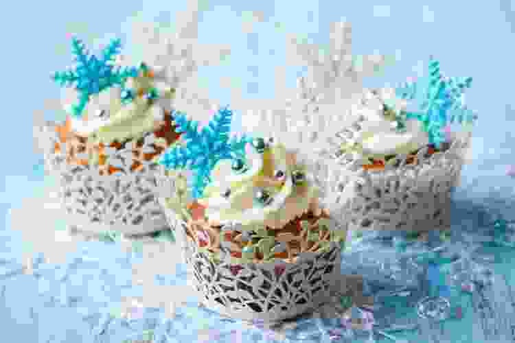 white cupcakes with blue sugar snowflakes on top