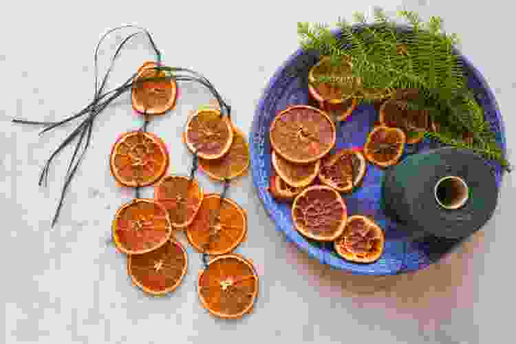 dried orange slices on string with greenery