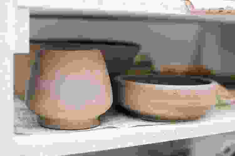 clay pots drying on rack