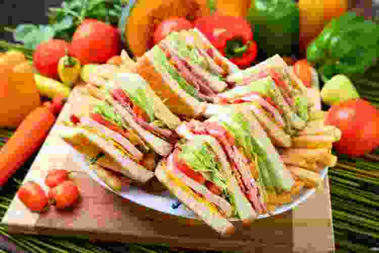 sliced club sandwich on cutting board