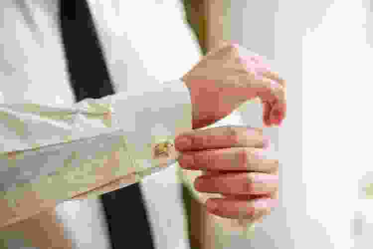 Man putting on cufflink