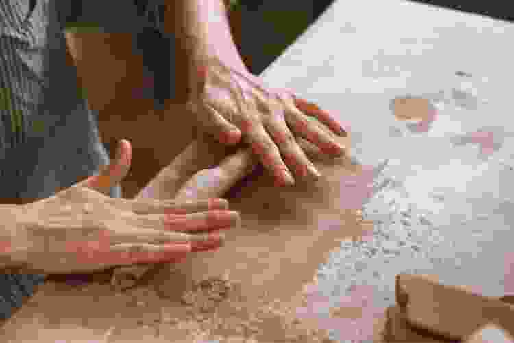 hand rolling clay to create a coil 