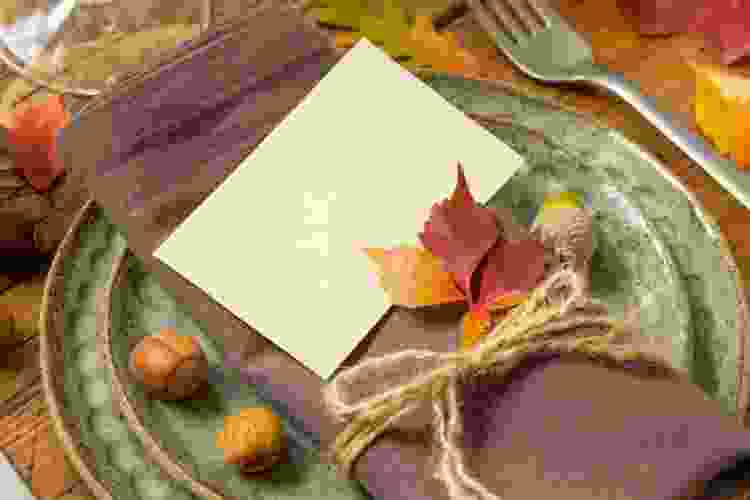 A fall-themed Thanksgiving table decor is to make Colorful Leaf Place Cards.