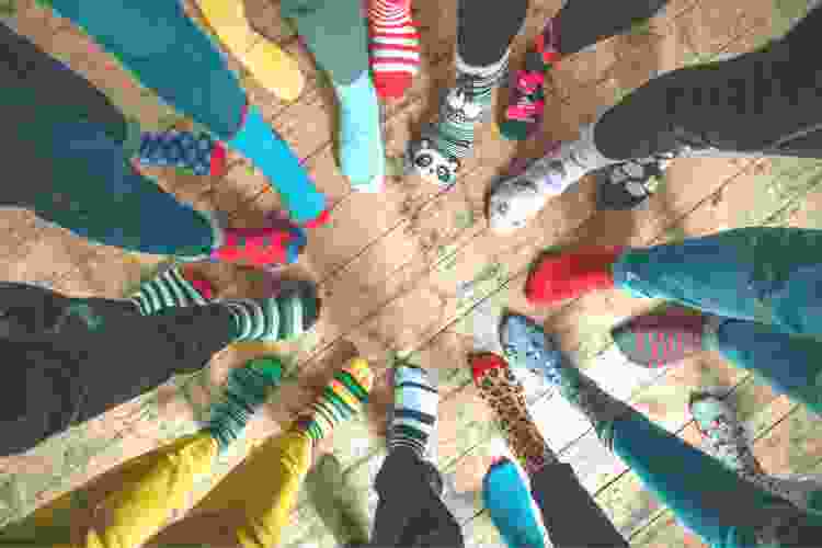 circle of feet wearing colorful patterned socks